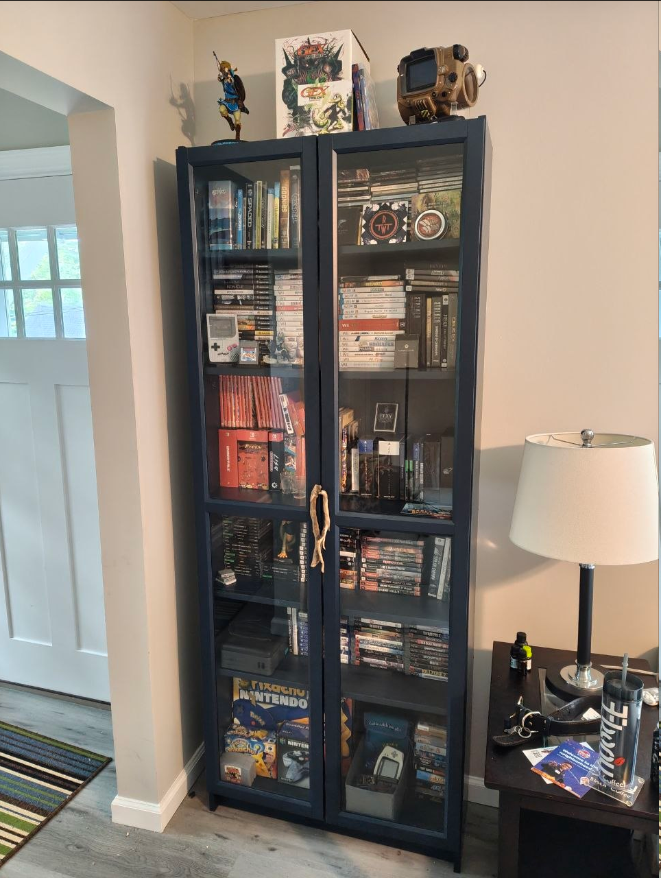 A bookshell filled to the brim with physical media including movies, games, and music.