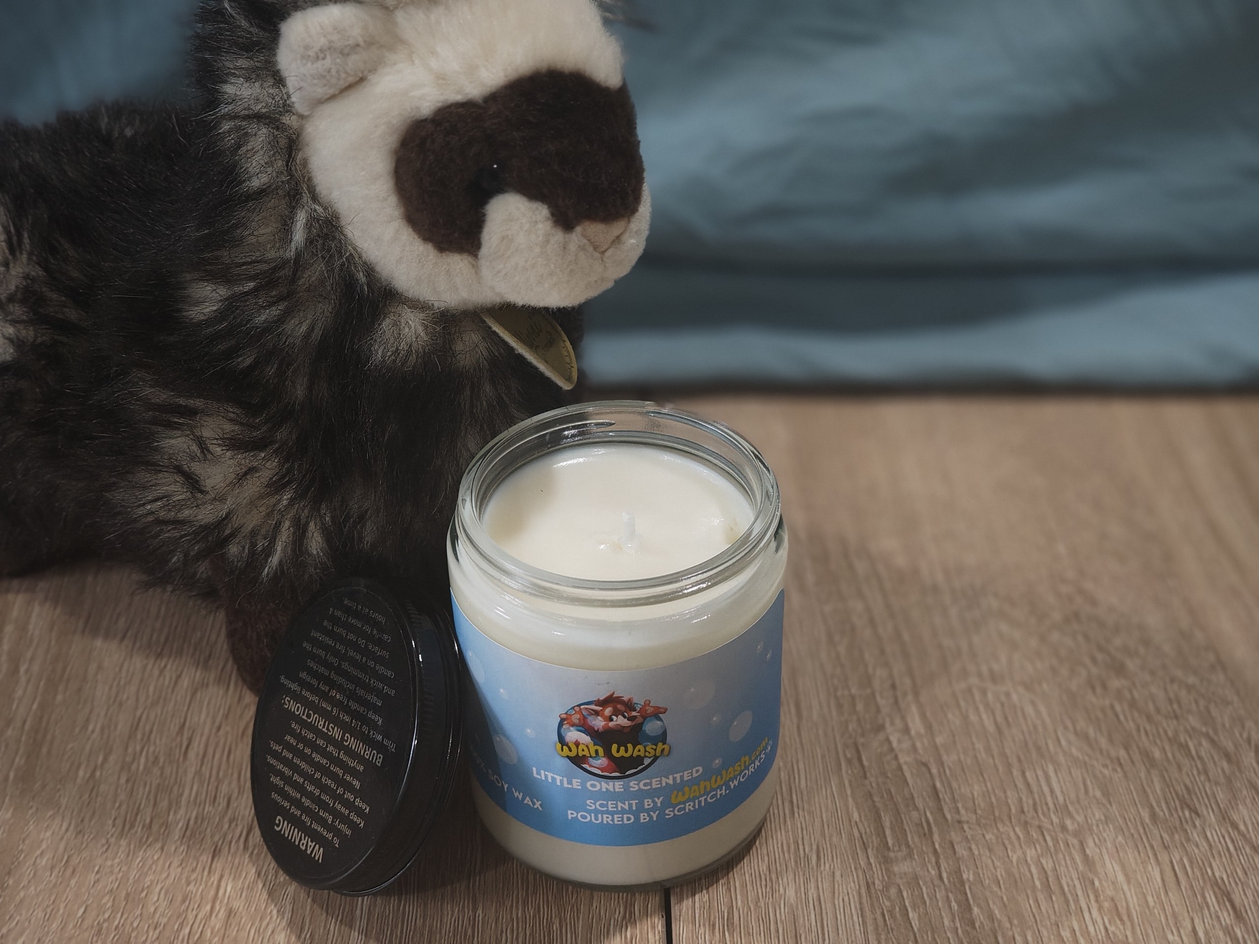 Scritch Plush sitting with a WahWash candle!